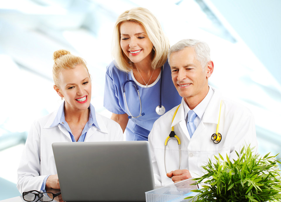 medical staff looking at the laptop